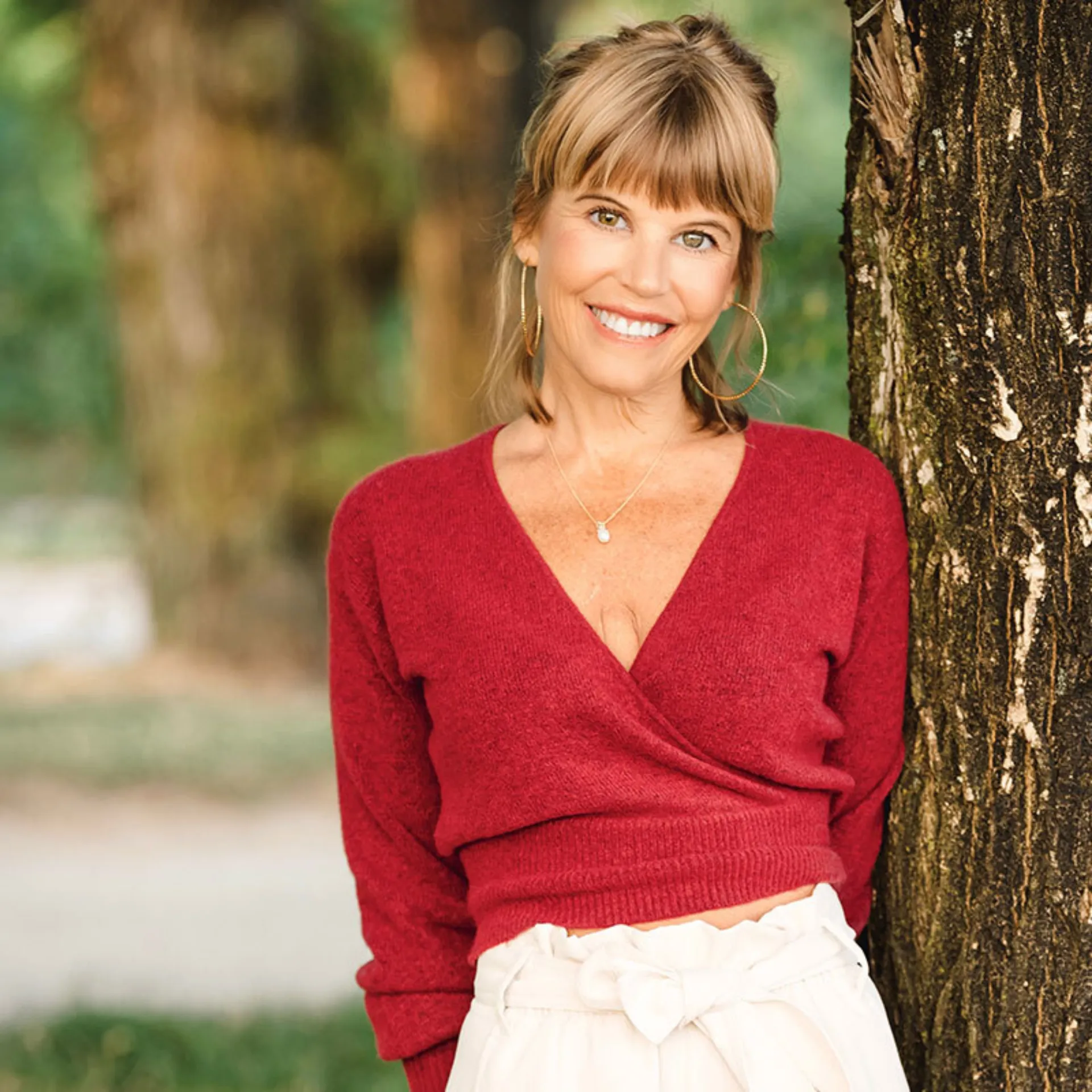 Erica Harris smiling beside a tree